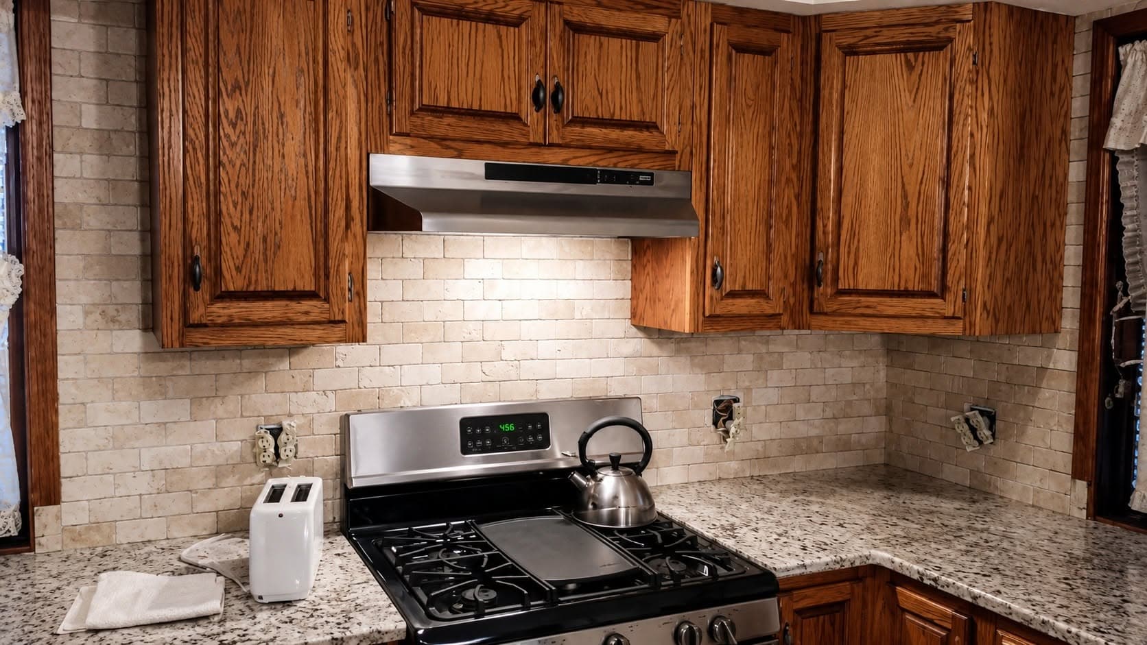 Completed kitchen with dark wood cabinets, subway tile backsplash, gas cooktop, and granite counters