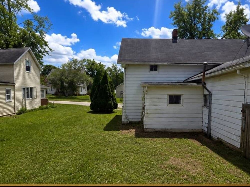 The same yard cleaned up with trimmed grass and clear, open space